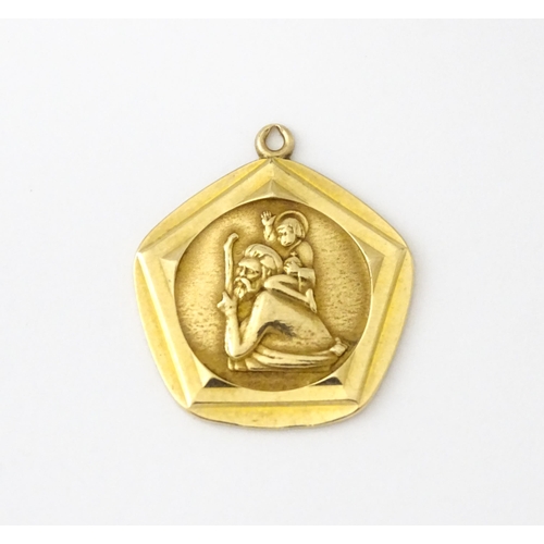 687 - A 9ct gold St Christopher pendant. Approx 3/4