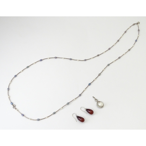 695 - Three items of jewellery comprising a silver pendant set with pearl, a necklace set with pearl beads... 