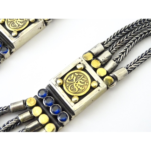 705 - An unusual white and yellow metal necklace set with blue stones and panels of Persian / Islamic scri... 