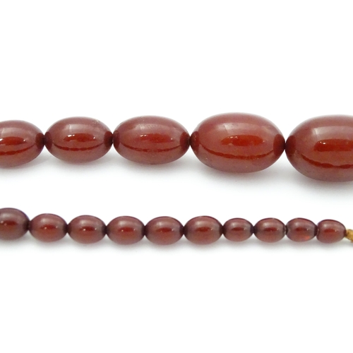 707 - A vintage necklace of graduated cherry amber coloured beads. Approx. 32