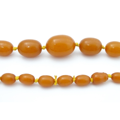 708 - A vintage necklace of graduated amber coloured beads. Approx. 24