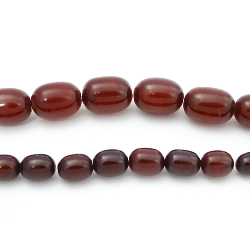 709 - A vintage necklace of graduated cherry amber coloured beads. Approx. 30