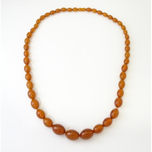 710 - A vintage necklace of graduated amber coloured beads. Approx. 3