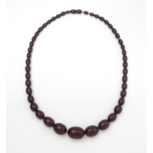 713 - A vintage necklace of graduated cherry amber coloured beads. Approx. 20