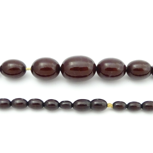 713 - A vintage necklace of graduated cherry amber coloured beads. Approx. 20