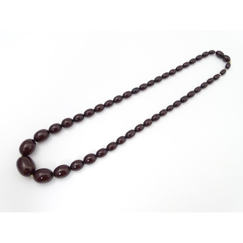 713 - A vintage necklace of graduated cherry amber coloured beads. Approx. 20