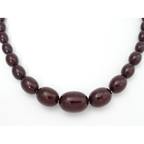 713 - A vintage necklace of graduated cherry amber coloured beads. Approx. 20