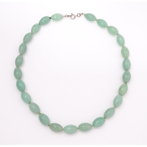 715 - A necklace of jade coloured beads. Approx. 16