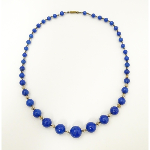 718 - A vintage graduated blue glass bead necklace with lapis lazuli style finish. Approx. 18