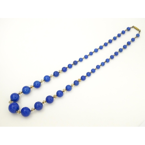 718 - A vintage graduated blue glass bead necklace with lapis lazuli style finish. Approx. 18