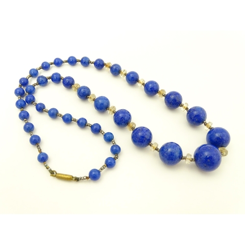 718 - A vintage graduated blue glass bead necklace with lapis lazuli style finish. Approx. 18