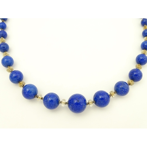 718 - A vintage graduated blue glass bead necklace with lapis lazuli style finish. Approx. 18