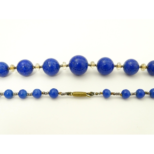 718 - A vintage graduated blue glass bead necklace with lapis lazuli style finish. Approx. 18