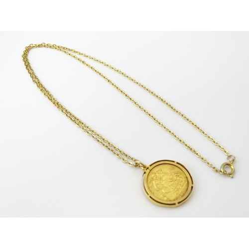 720 - Coin: A 1914 George V gold sovereign in yellow metal captive pendant mount, with 22