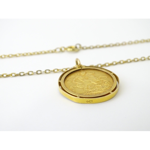 720 - Coin: A 1914 George V gold sovereign in yellow metal captive pendant mount, with 22