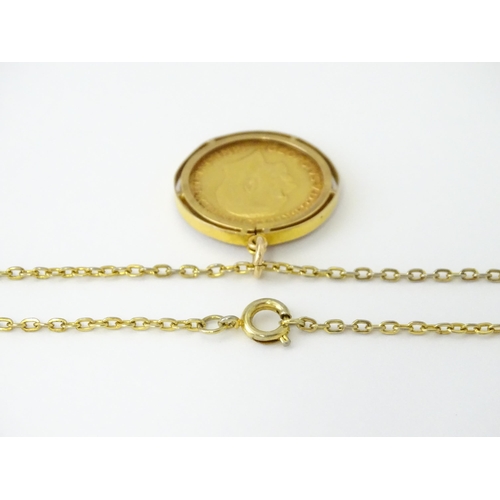 720 - Coin: A 1914 George V gold sovereign in yellow metal captive pendant mount, with 22