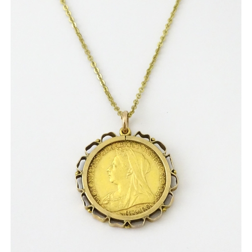 721 - Coin: An 1897 Victorian gold sovereign in yellow metal captive pendant mount, with 18