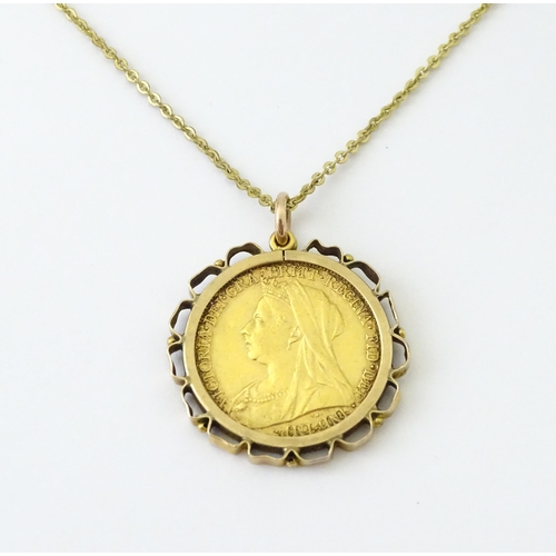 721 - Coin: An 1897 Victorian gold sovereign in yellow metal captive pendant mount, with 18