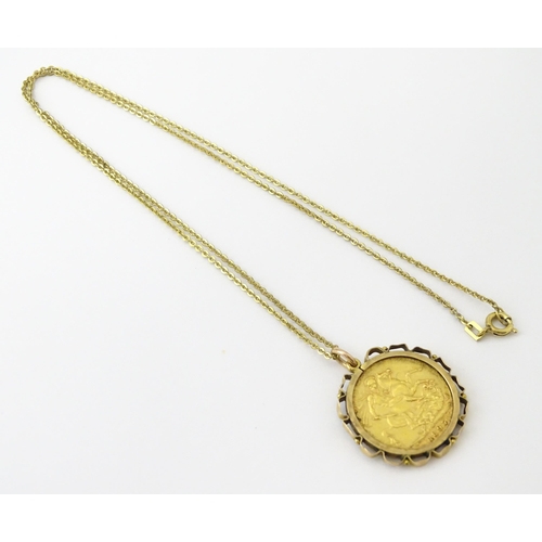 721 - Coin: An 1897 Victorian gold sovereign in yellow metal captive pendant mount, with 18