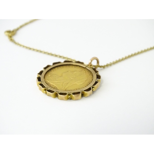 721 - Coin: An 1897 Victorian gold sovereign in yellow metal captive pendant mount, with 18