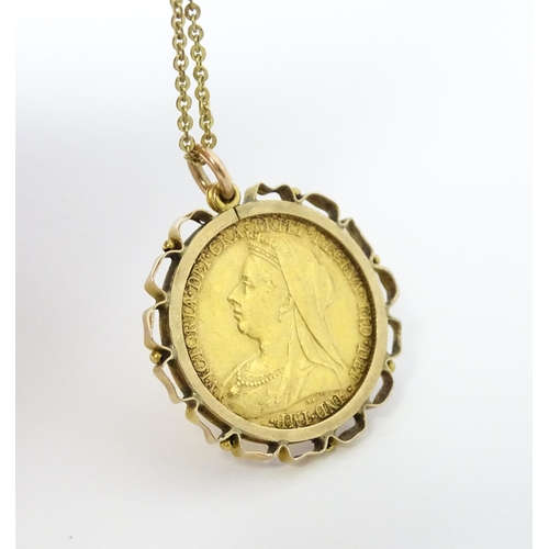 721 - Coin: An 1897 Victorian gold sovereign in yellow metal captive pendant mount, with 18