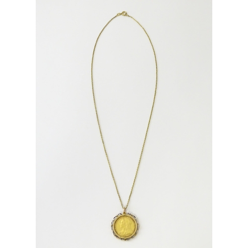 721 - Coin: An 1897 Victorian gold sovereign in yellow metal captive pendant mount, with 18