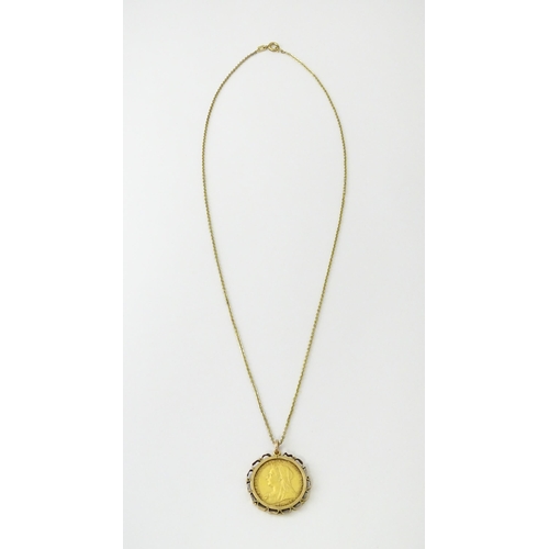 721 - Coin: An 1897 Victorian gold sovereign in yellow metal captive pendant mount, with 18