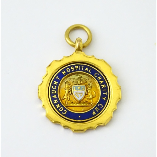 724 - Football Interest : A 9ct gold medal / fob with enamel detail, titled Connaught Hospital Charity Cup... 