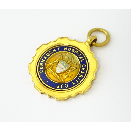 724 - Football Interest : A 9ct gold medal / fob with enamel detail, titled Connaught Hospital Charity Cup... 