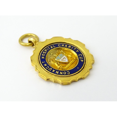 724 - Football Interest : A 9ct gold medal / fob with enamel detail, titled Connaught Hospital Charity Cup... 