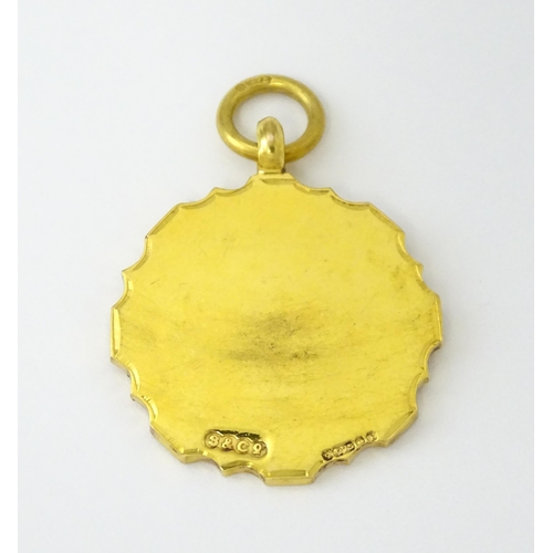 724 - Football Interest : A 9ct gold medal / fob with enamel detail, titled Connaught Hospital Charity Cup... 