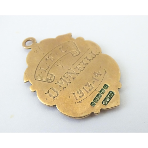 725 - Football Interest : A 9ct gold medal / fob depicting the Coat of Arms of Belfast, and ascribed to th... 