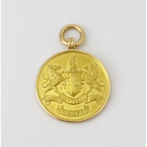 729 - Football Interest : A cased 15ct gold medal / fob for London Football Association Challenge Cup, hal... 