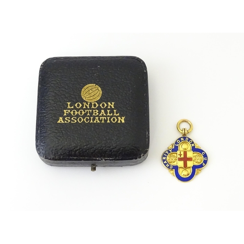 731 - Football Interest : A cased 9ct gold medal / fob with enamel decoration for London Charity Cup, and ... 