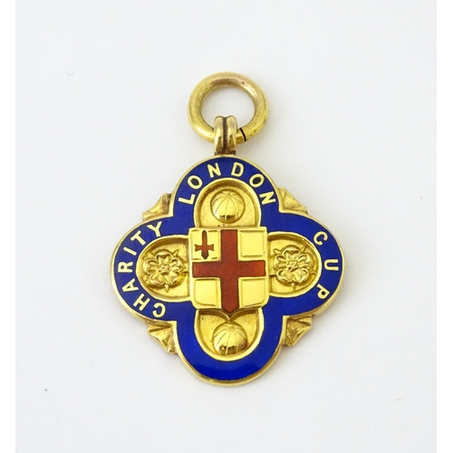 731 - Football Interest : A cased 9ct gold medal / fob with enamel decoration for London Charity Cup, and ... 