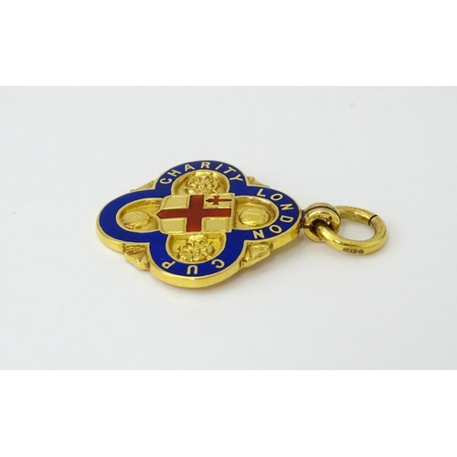 731 - Football Interest : A cased 9ct gold medal / fob with enamel decoration for London Charity Cup, and ... 