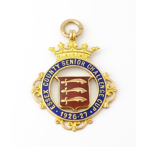 732 - Football Interest : A cased 9ct gold medal / fob with enamel decoration for Essex County Senior Chal... 