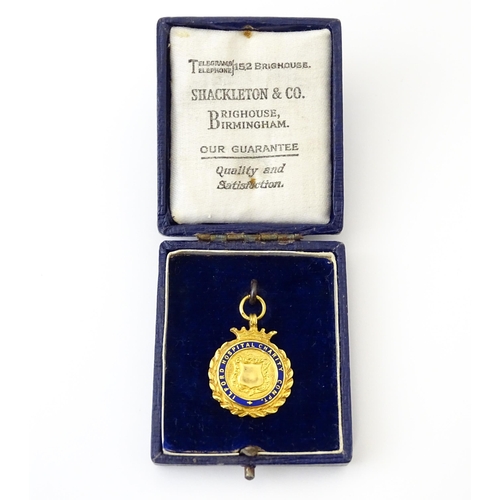 733 - Football Interest : A cased 9ct gold medal / fob with enamel decoration for Ilford Hospital Charity ... 