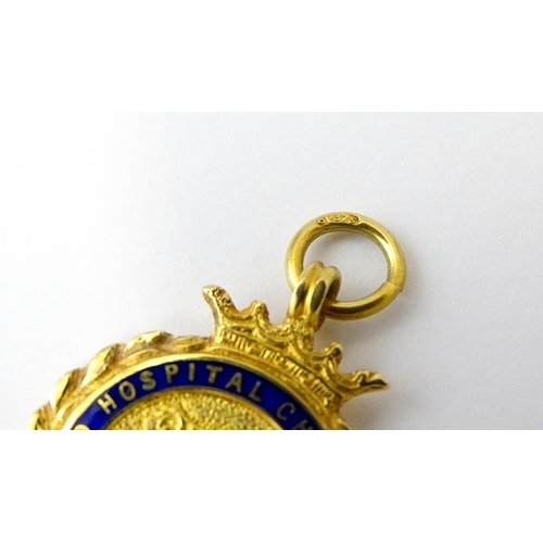 733 - Football Interest : A cased 9ct gold medal / fob with enamel decoration for Ilford Hospital Charity ... 