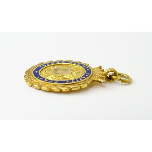 733 - Football Interest : A cased 9ct gold medal / fob with enamel decoration for Ilford Hospital Charity ... 