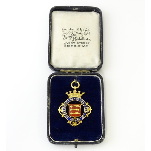 734 - Football Interest : A cased 9ct gold medal / fob with enamel decoration for Essex County Senior Chal... 