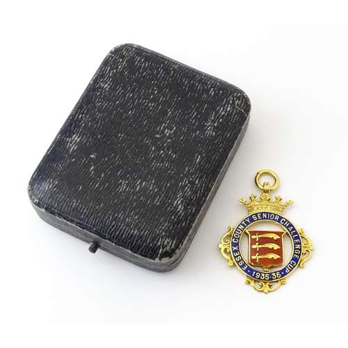 734 - Football Interest : A cased 9ct gold medal / fob with enamel decoration for Essex County Senior Chal... 