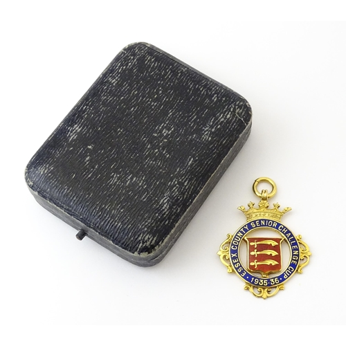 734 - Football Interest : A cased 9ct gold medal / fob with enamel decoration for Essex County Senior Chal... 