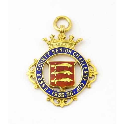 734 - Football Interest : A cased 9ct gold medal / fob with enamel decoration for Essex County Senior Chal... 