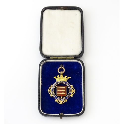 735 - Football Interest : A cased 9ct gold medal / fob with enamel decoration for Essex County Senior Chal... 