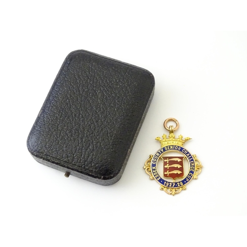 735 - Football Interest : A cased 9ct gold medal / fob with enamel decoration for Essex County Senior Chal... 