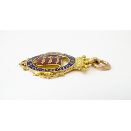 735 - Football Interest : A cased 9ct gold medal / fob with enamel decoration for Essex County Senior Chal... 