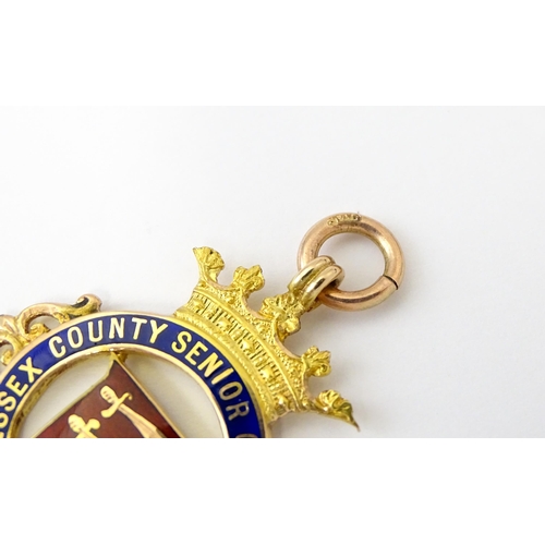 735 - Football Interest : A cased 9ct gold medal / fob with enamel decoration for Essex County Senior Chal... 