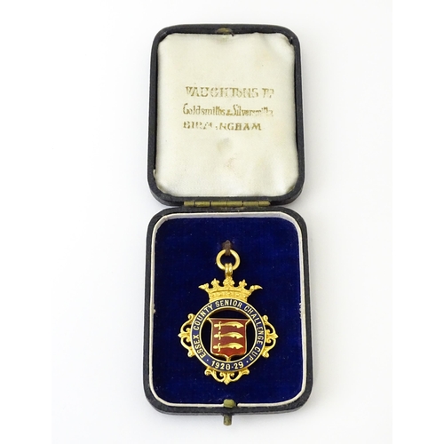 736 - Football Interest : A cased 9ct gold medal / fob with enamel decoration for Essex County Senior Chal... 