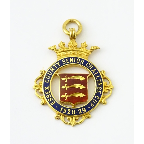 736 - Football Interest : A cased 9ct gold medal / fob with enamel decoration for Essex County Senior Chal... 